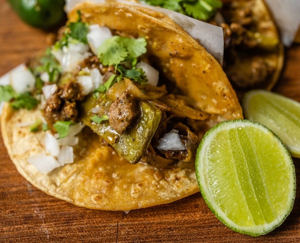 Full-service catering setup with warming trays of tacos, rice and beans