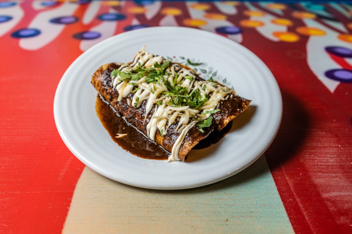 Hand-pressed corn tortilla tacos topped with cilantro, onion and salsa verde at R&R Taqueria